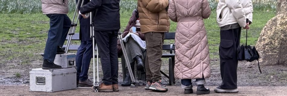 Discreet security protecting high profile talent during filming in a public location